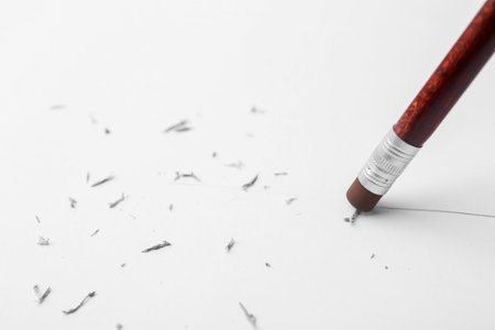 Graphite pencil with eraser on paper sheet, closeupの写真素材