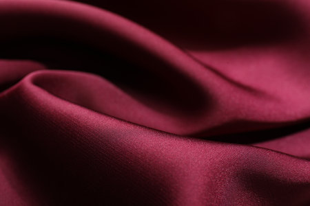 Crumpled burgundy silk fabric as background, closeupの写真素材