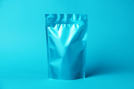 One zipper stand-up pouch on light blue background. Mockup for designの写真素材
