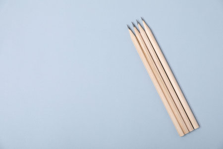 Many graphite pencils on gray background, flat lay. Space for textの写真素材