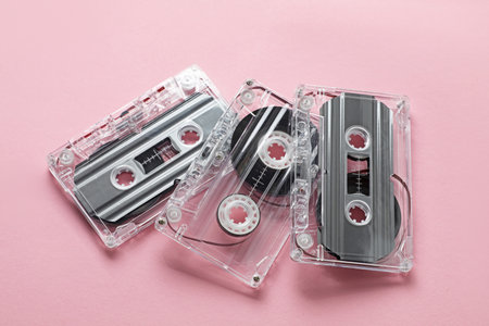 Audio cassettes with magnetic tapes on pink background, above viewの写真素材