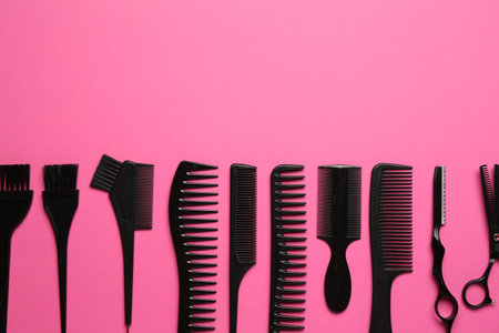 Different hairdresser's tools on pink background, flat lay. Space for textの写真素材