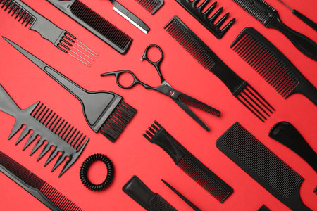 Different hairdresser's tools on red background, flat layの写真素材