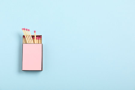 Matches in box on light blue background, top view. Mockup for designの写真素材