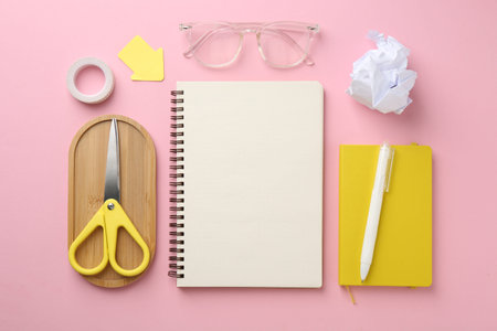 Flat lay composition with notebooks on pink background