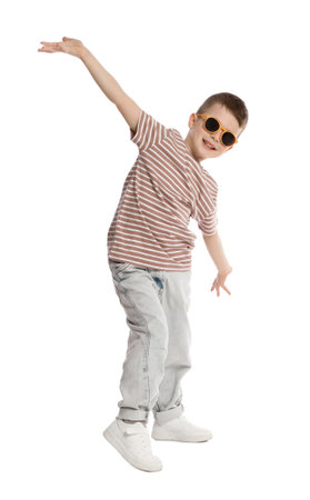 Happy little boy in sunglasses dancing on white backgroundの写真素材