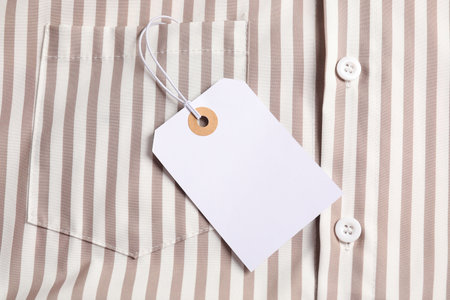 Cardboard tag on striped shirt, top view
