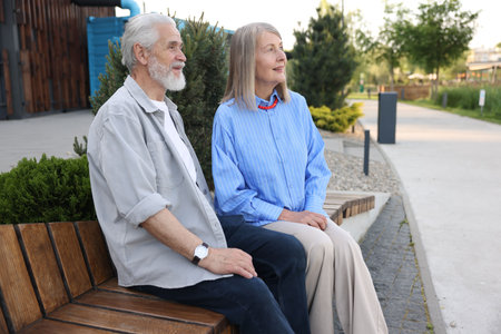 Lovely senior couple on bench in park