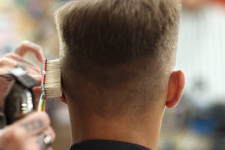 Professional barber making stylish haircut in barbershop, closeupの写真素材