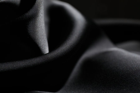 Crumpled black silk fabric as background, closeupの写真素材