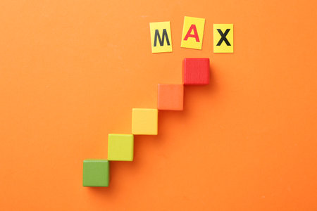 Colorful cubes and word Max on orange background, flat layの写真素材