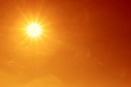 Bright sun in orange sky during hot summer weather. Extremely high temperature