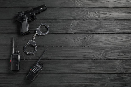Different police equipment on black wooden table, flat lay. Space for textの写真素材