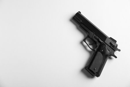 Police equipment. One black gun on white background, top view. Space for textの写真素材