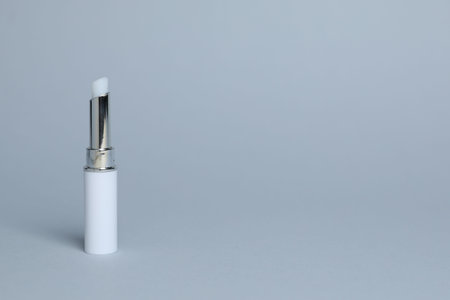 One white lipstick on light gray background, space for textの写真素材