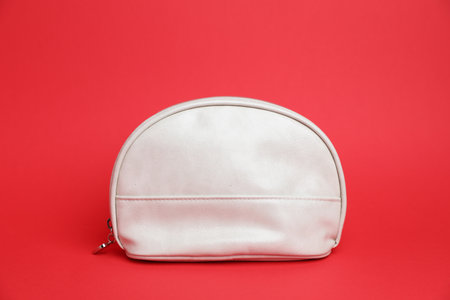 One white cosmetic bag on red backgroundの写真素材