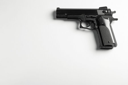Police equipment. One black gun on white background, top view. Space for text