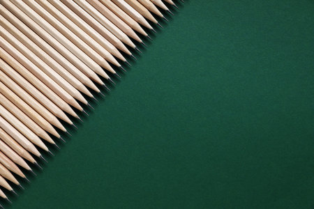 Many graphite pencils on green background, flat lay. Space for textの写真素材