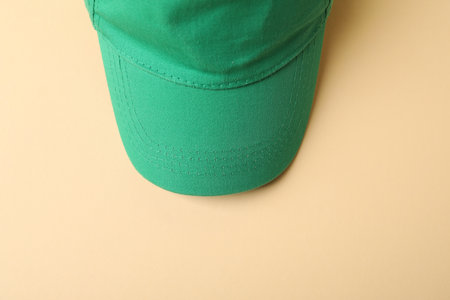 Green baseball hat on beige background, top viewの写真素材