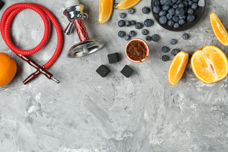 Hookah, coal and fresh fruits on gray table, flat lay. Space for textの写真素材
