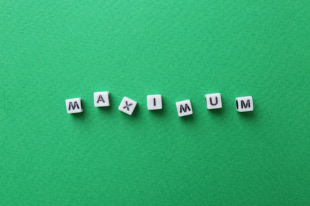 Word Maximum made of cubes on green background, top viewの写真素材
