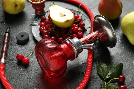 Hookah and fresh fruits on black table, closeup
