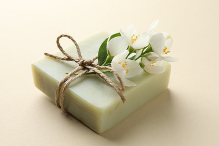 Soap bar and jasmine flowers on beige background, closeupの写真素材