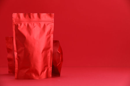 Zipper stand-up pouches on red background. Mockup for designの写真素材
