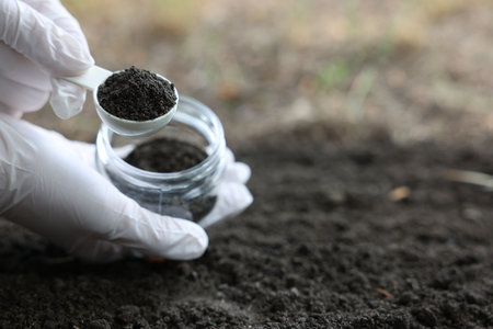 Scientist soil taking sample for research outdoors, closeup. Space for textの写真素材