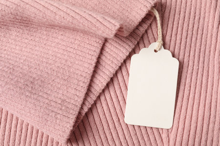 Cardboard tag on garment pink, top viewの写真素材