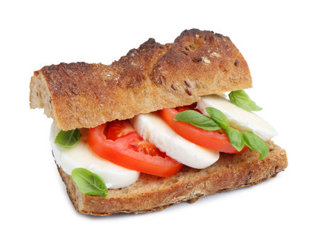 Tasty sandwich with mozzarella cheese, tomatoes and basil isolated on whiteの写真素材