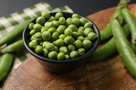 Fresh ripe green peas on black table, closeupの写真素材