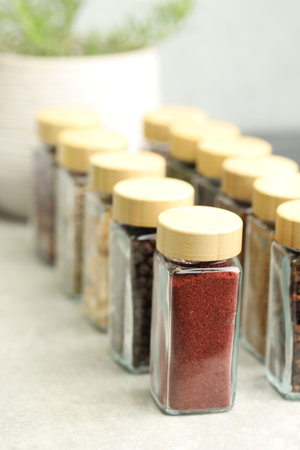 Many different aromatic spices in jars on table indoors, closeupの写真素材