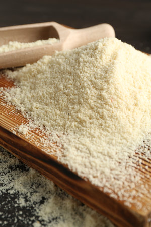 Pile of flour and scoop on table, closeupの写真素材
