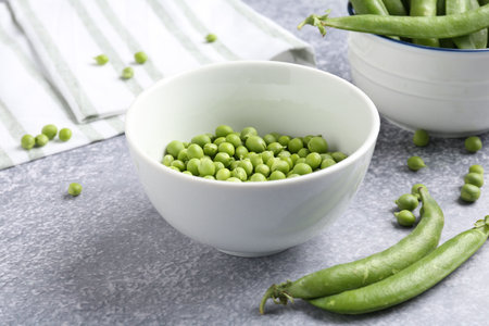 Fresh ripe green peas on gray table, closeupの写真素材
