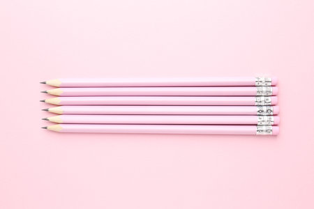 Many graphite pencils on pink background, flat layの写真素材