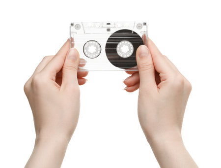 Woman with audio cassette on white background, closeupの写真素材