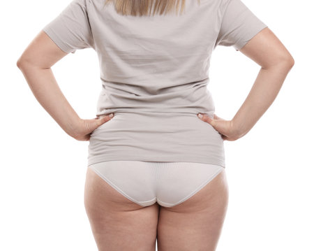 Weight loss. Plus size woman on white background, closeupの写真素材