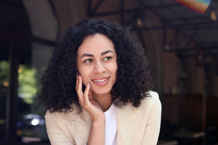 Portrait of smiling Latin American woman outdoorsの写真素材