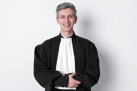 Smiling judge in court dress on light background