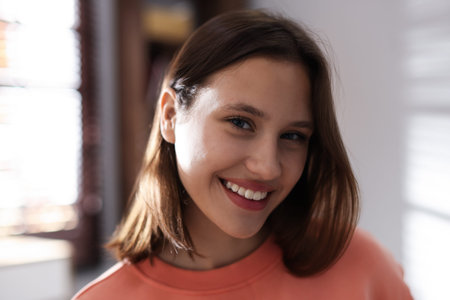 Portrait of smiling teenage girl at home, closeup
