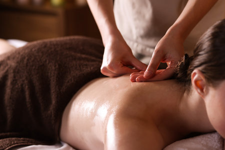 Woman receiving back massage with oil in spa salon, closeupの写真素材