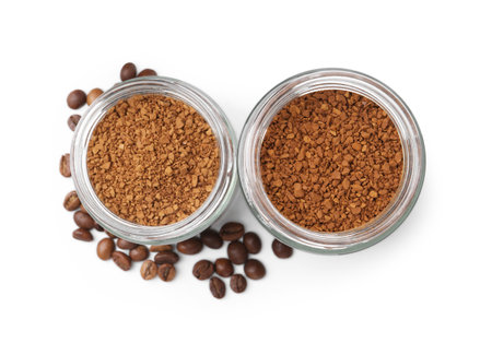 Instant coffee in jars and beans isolated on white, top viewの写真素材