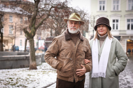 Lovely senior couple walking on city street. Space for textの写真素材