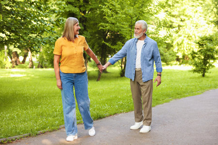 Lovely senior couple walking together in park