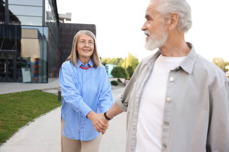 Lovely senior couple walking together in park
