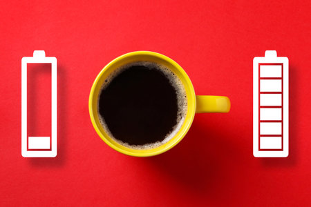 Cup of coffee and battery indicators on red background, top view. Restoring energy with caffeine