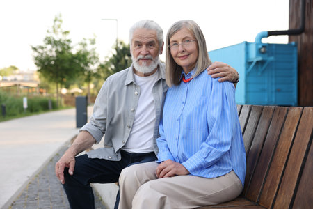 Lovely senior couple on bench near building outdoorsの写真素材
