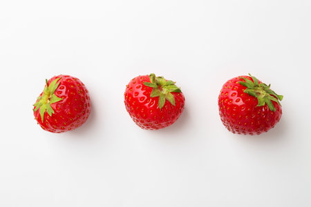 Fresh ripe strawberries on white background, flat layの写真素材