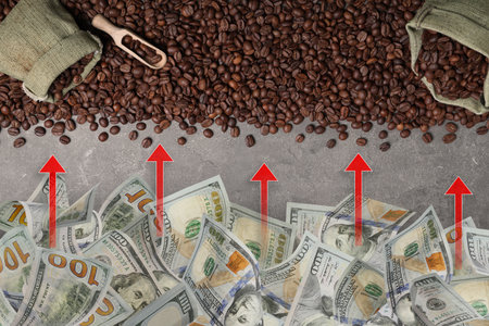Roasted beans and dollar bills with red arrows on gray tableの写真素材